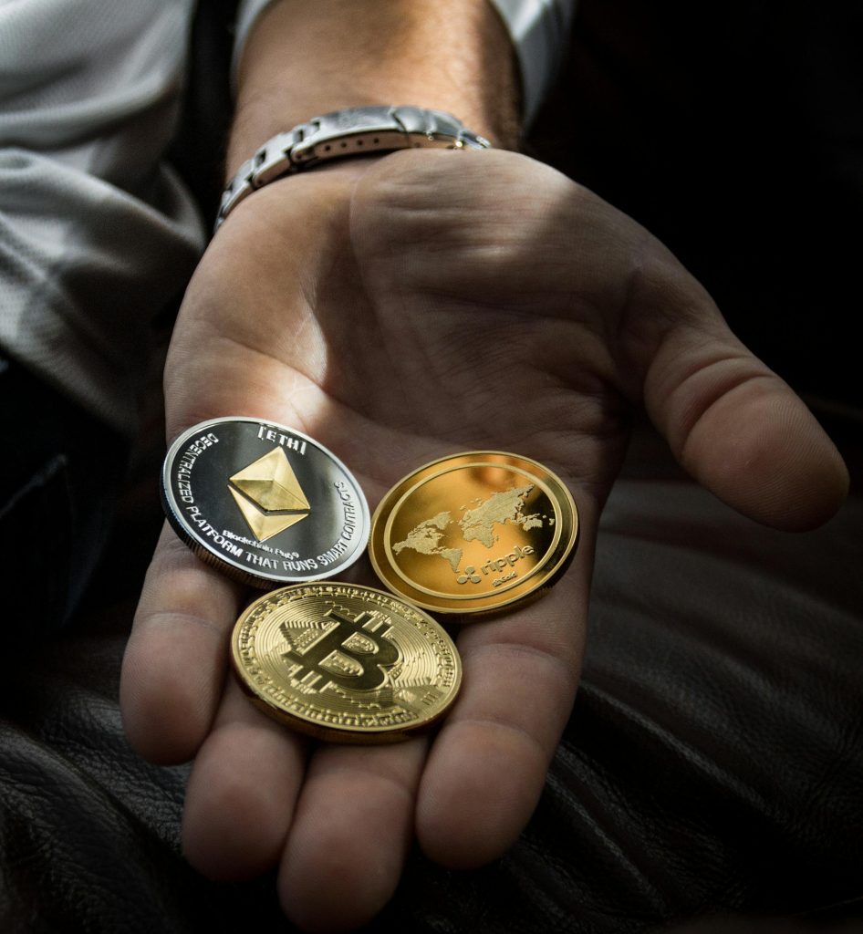 Image of a hand holding Crypto coins